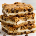 Delicious cheesecake stuffed chocolate chip cookies stacked on a plate