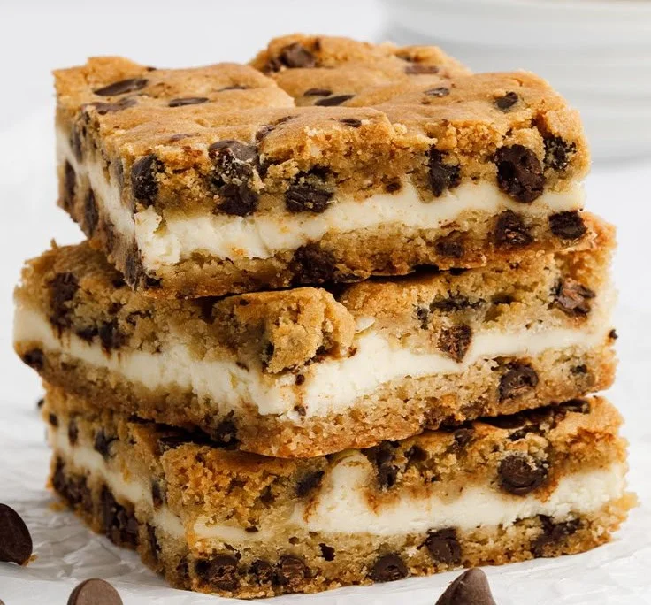 Delicious cheesecake stuffed chocolate chip cookies stacked on a plate