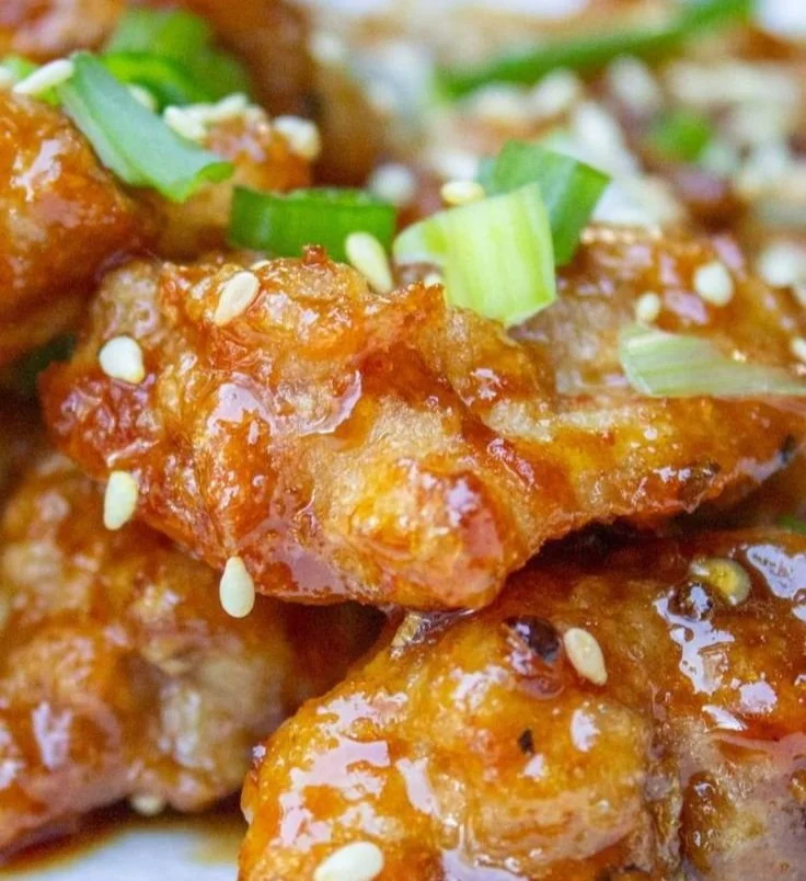 Delicious Chinese Honey Garlic Chicken served with vegetables on a plate.