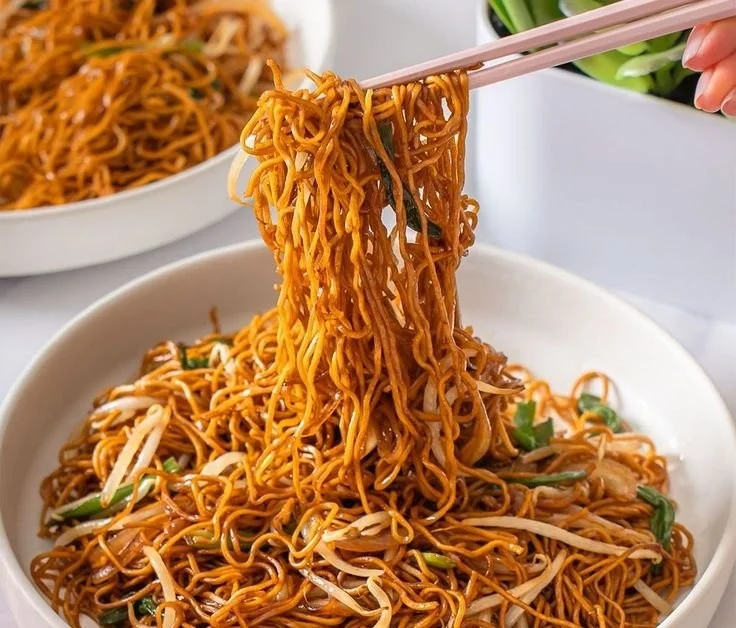 Delicious classic Chinese Chow Mein served in a bowl with vegetables and noodles.