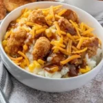 A delicious bowl of homemade Copycat KFC Bowls with layers of chicken, corn, and mashed potatoes.
