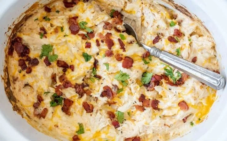 Delicious Crack Chicken served on a plate with herbs and spices.