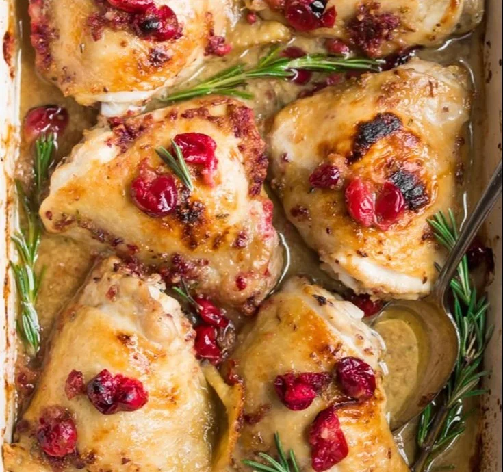 One pan cranberry rosemary chicken thighs served with herbs and cranberries