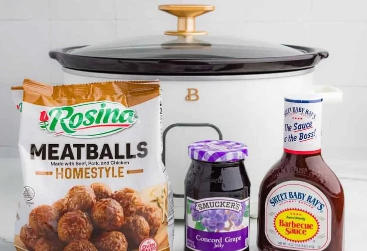 Crockpot BBQ grape jelly meatballs served in a bowl with toothpicks