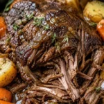 Delicious crockpot pot roast with vegetables and herbs in a slow cooker.