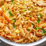 Delicious Easy Chicken Pad Thai served with lime and peanuts