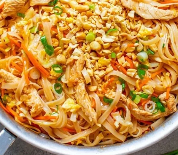 Delicious Easy Chicken Pad Thai served with lime and peanuts