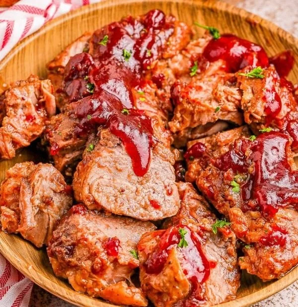 Delicious cranberry glazed pork tenderloin served on a plate