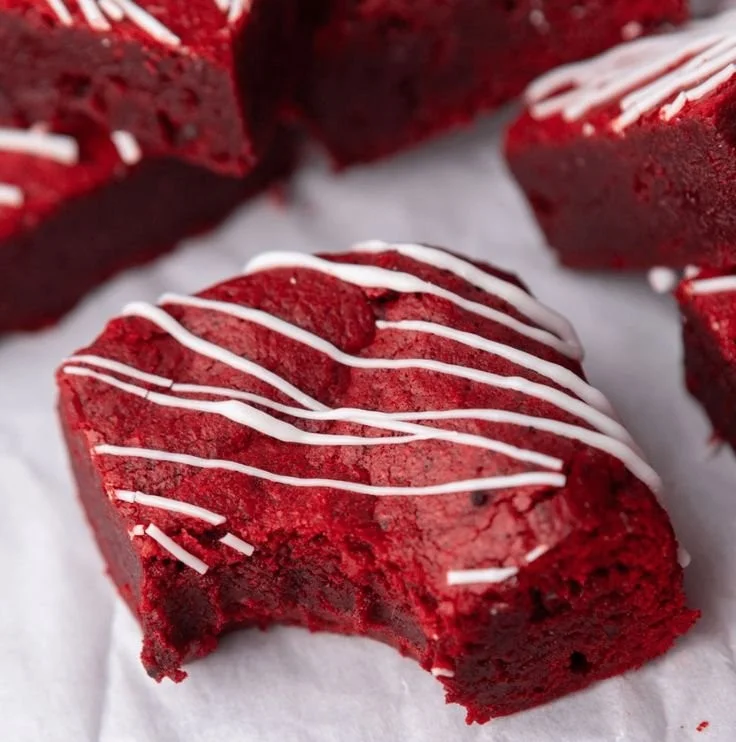 Fudgy red velvet brownies topped with cream cheese frosting