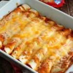 Delicious beef enchiladas topped with cheese and sauce, ready to serve.