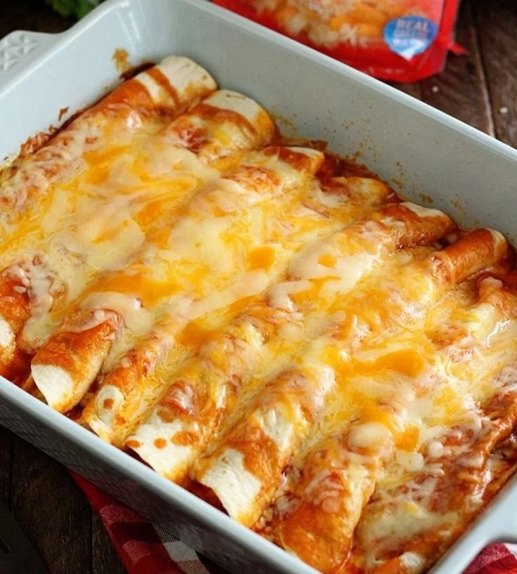 Delicious beef enchiladas topped with cheese and sauce, ready to serve.