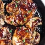 Delicious raspberry balsamic glazed pork chops on a plate