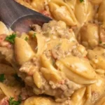 Plate of creamy Rotel Pasta garnished with fresh herbs
