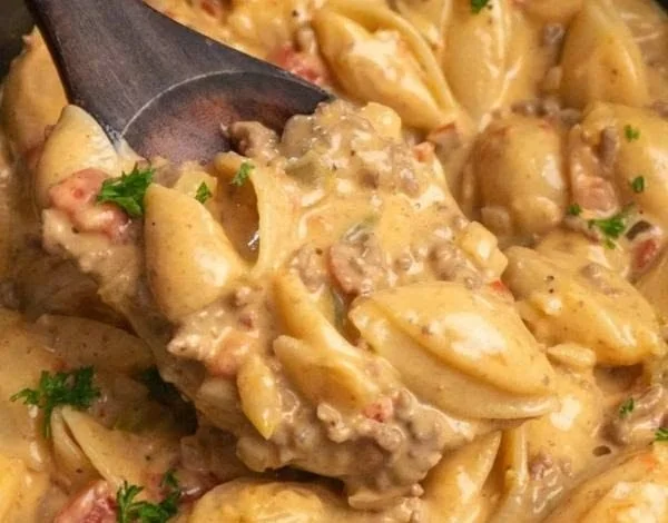 Plate of creamy Rotel Pasta garnished with fresh herbs