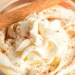 A warm mug of slow cooker pumpkin hot chocolate topped with whipped cream