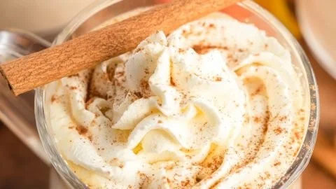A warm mug of slow cooker pumpkin hot chocolate topped with whipped cream