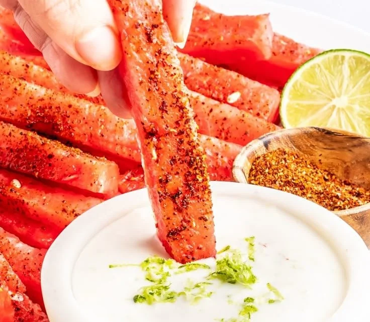 Spicy watermelon fries served in a bowl with a dipping sauce
