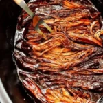 Deliciously tender BBQ brisket served with sides at a cookout.