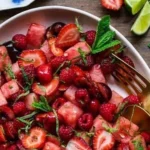 A vibrant watermelon fruit salad topped with lime mint dressing.