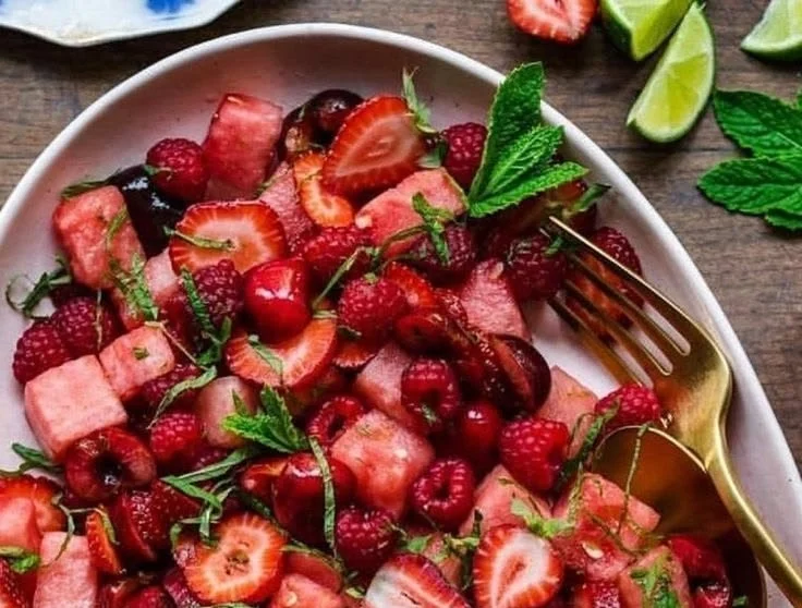 A vibrant watermelon fruit salad topped with lime mint dressing.